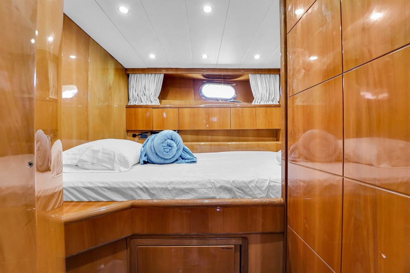 a bed with a blue pillow aboard STAMOS BIEN Yacht for Sale