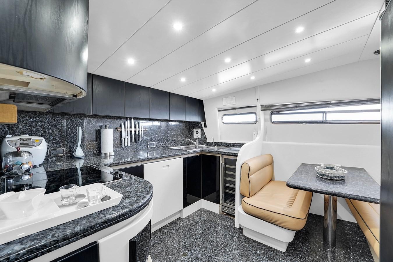 a kitchen with a chair and a table aboard STAMOS BIEN Yacht for Sale