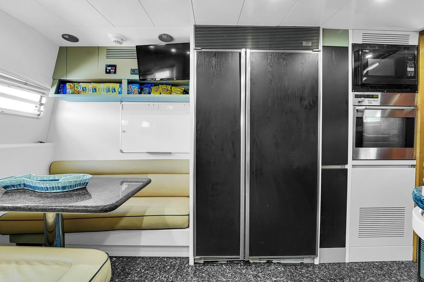 a large black refrigerator in a kitchen aboard STAMOS BIEN Yacht for Sale