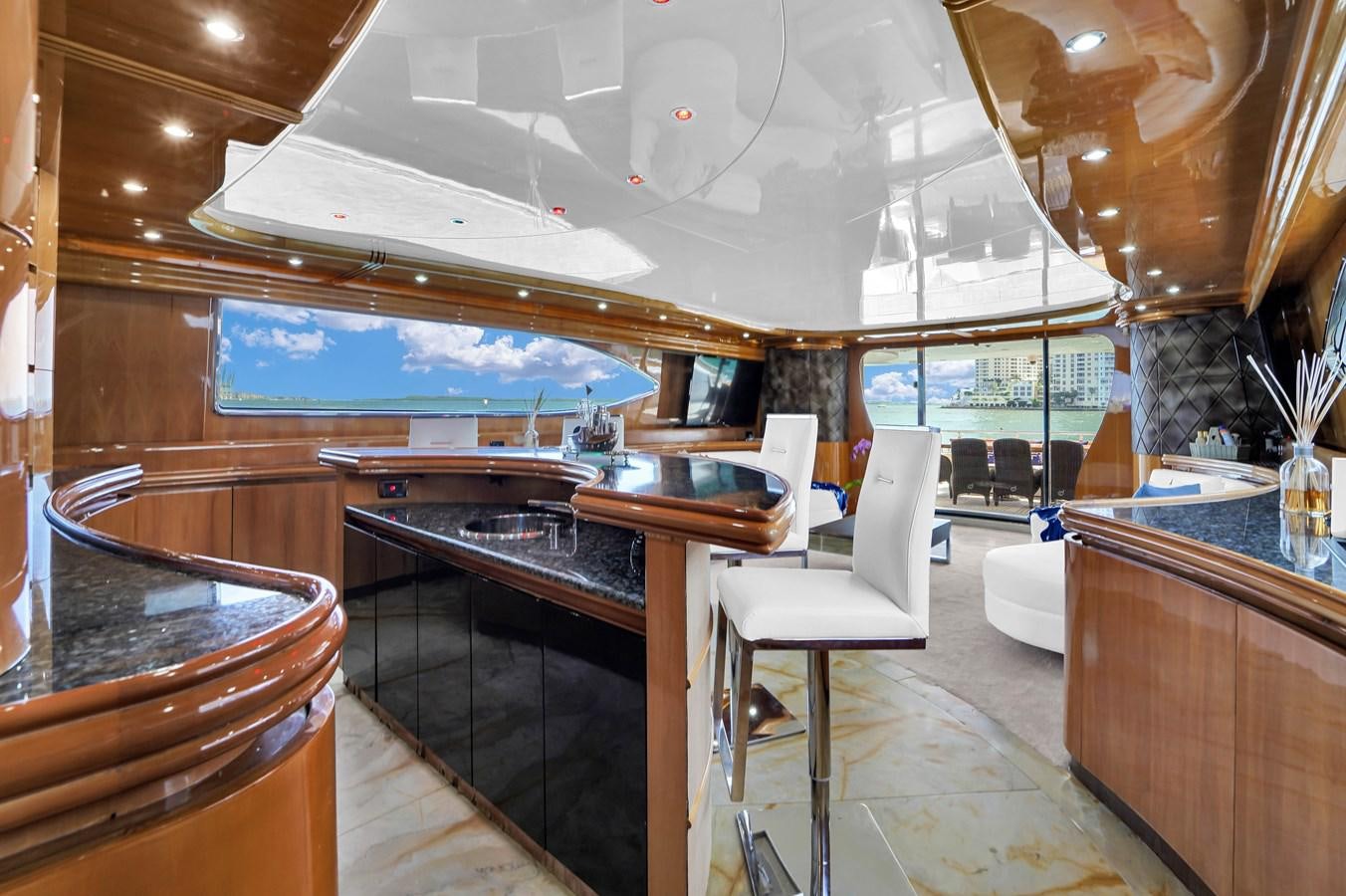a large kitchen with a bar and chairs aboard STAMOS BIEN Yacht for Sale