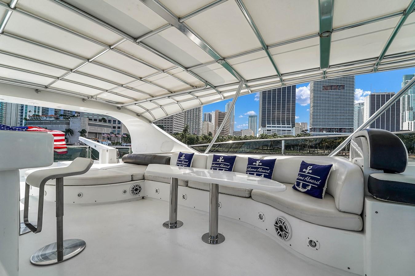 a large white bench in a large room with a large window and a view of a city aboard STAMOS BIEN Yacht for Sale