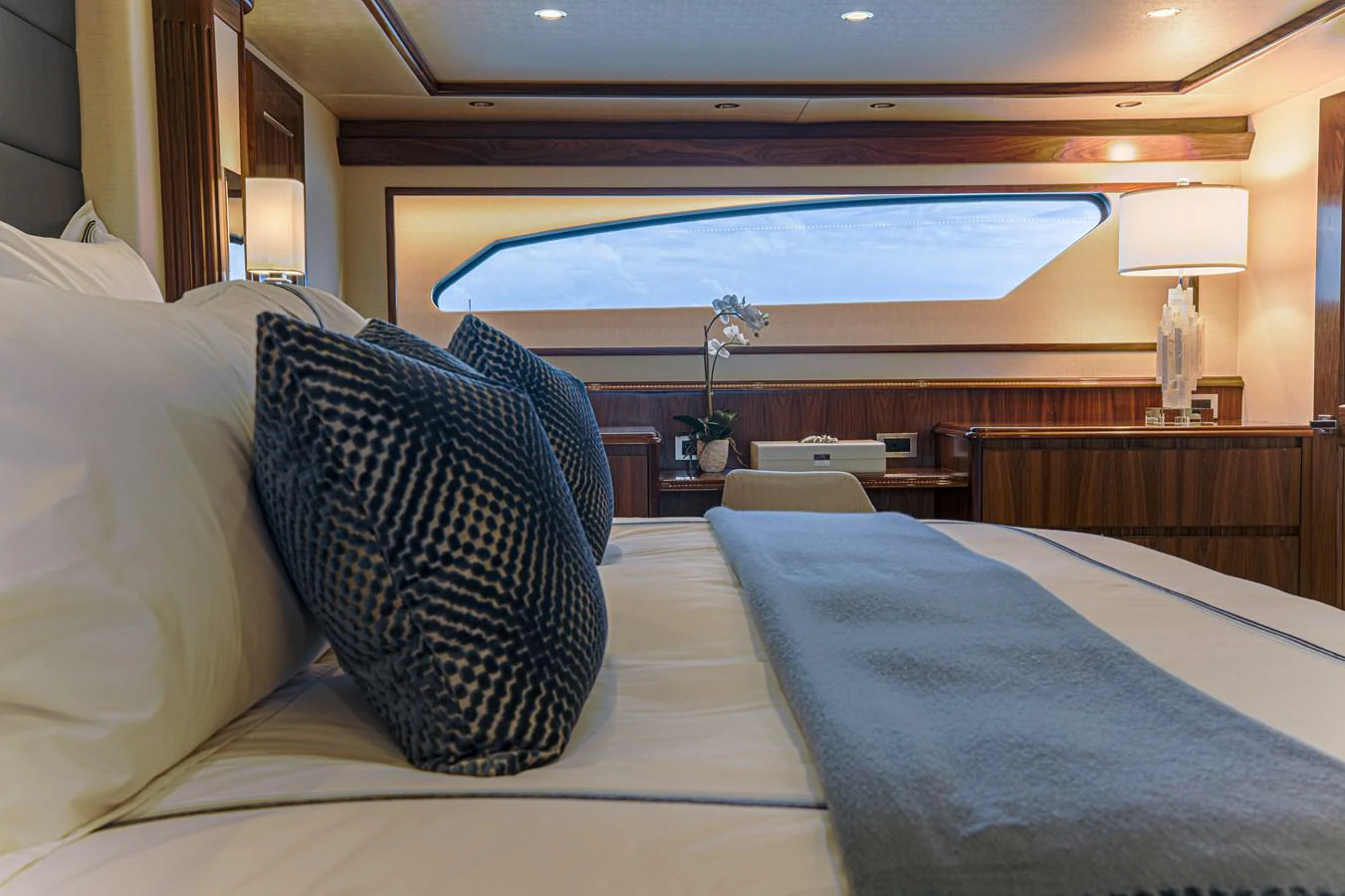 a bed with pillows and a large window aboard SPECULATOR Yacht for Sale