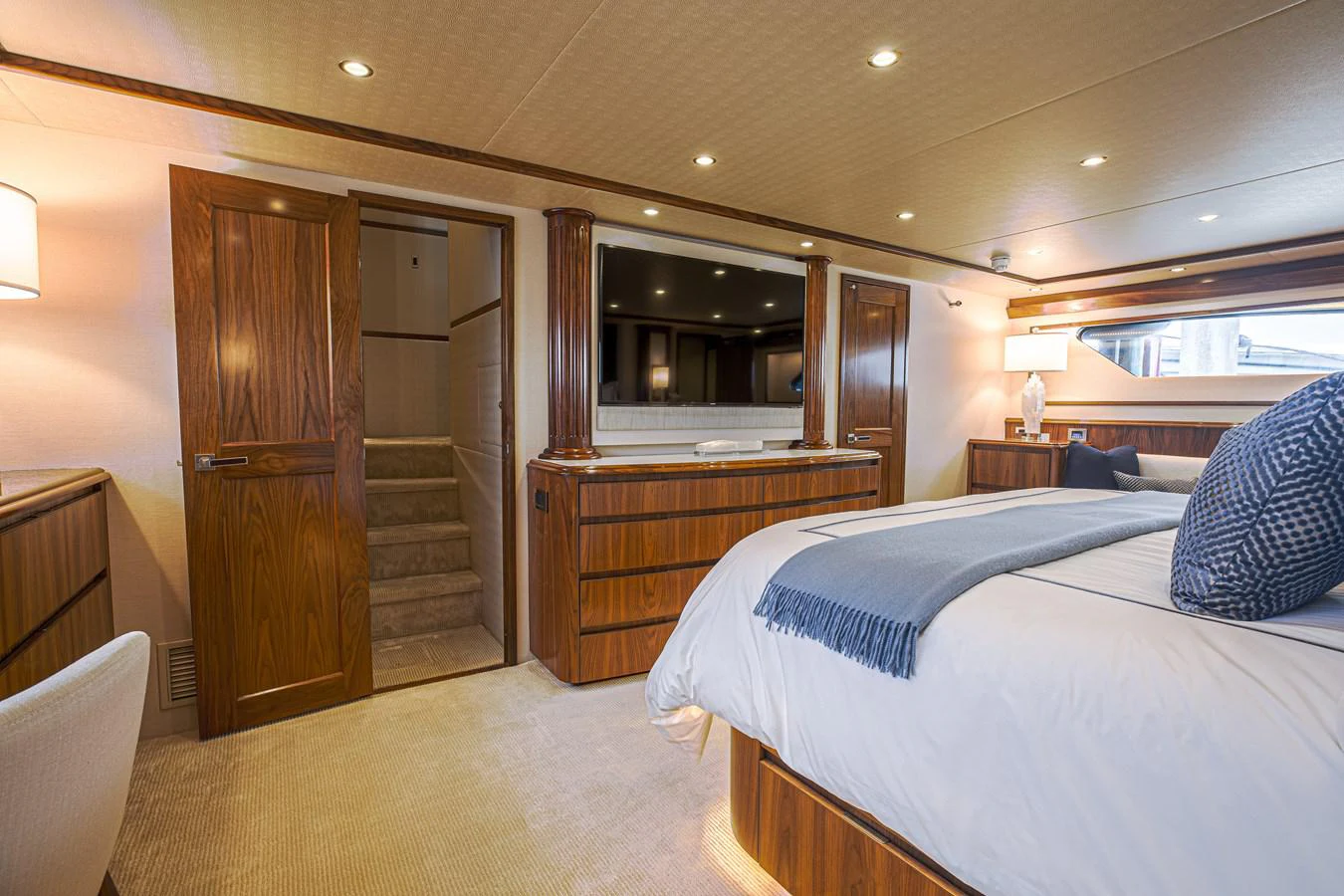 a bedroom with a bed and a closet aboard SPECULATOR Yacht for Sale