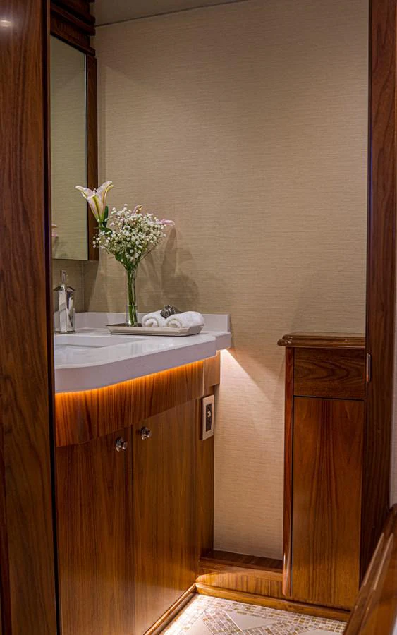 a bathroom with a sink and a vase with flowers aboard SPECULATOR Yacht for Sale