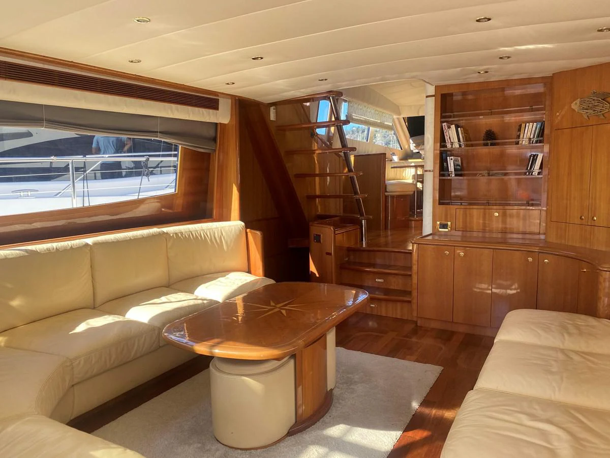 a room with a table and couch aboard AMADEUS Yacht for Sale