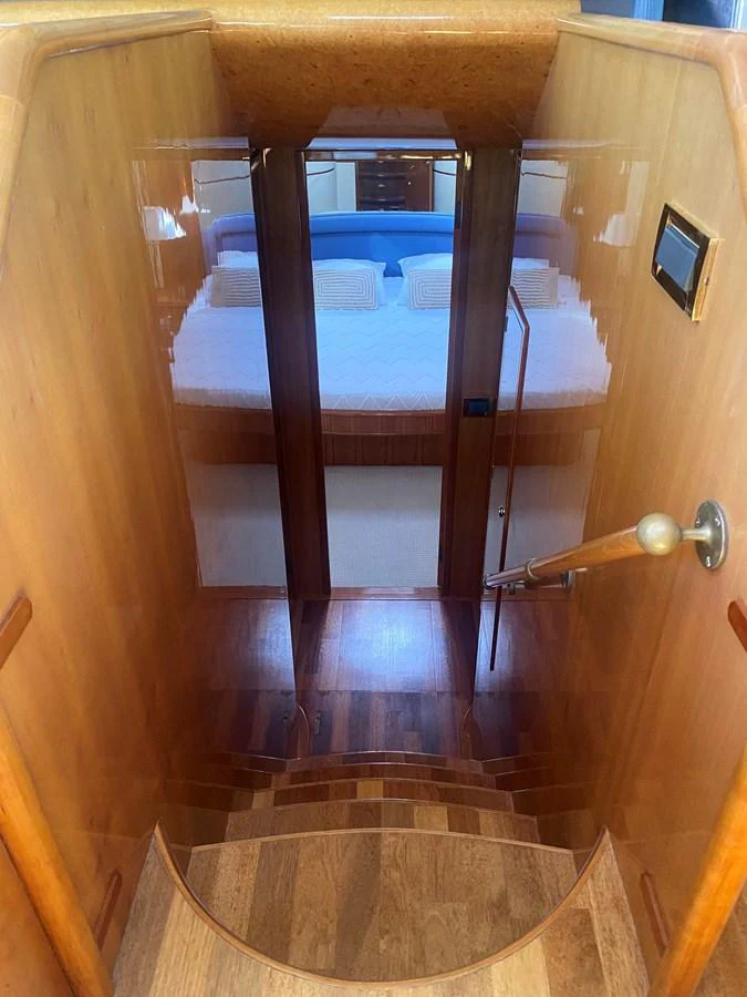 a wooden bunk bed aboard AMADEUS Yacht for Sale