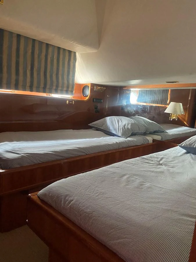 a couple of beds in a room aboard AMADEUS Yacht for Sale