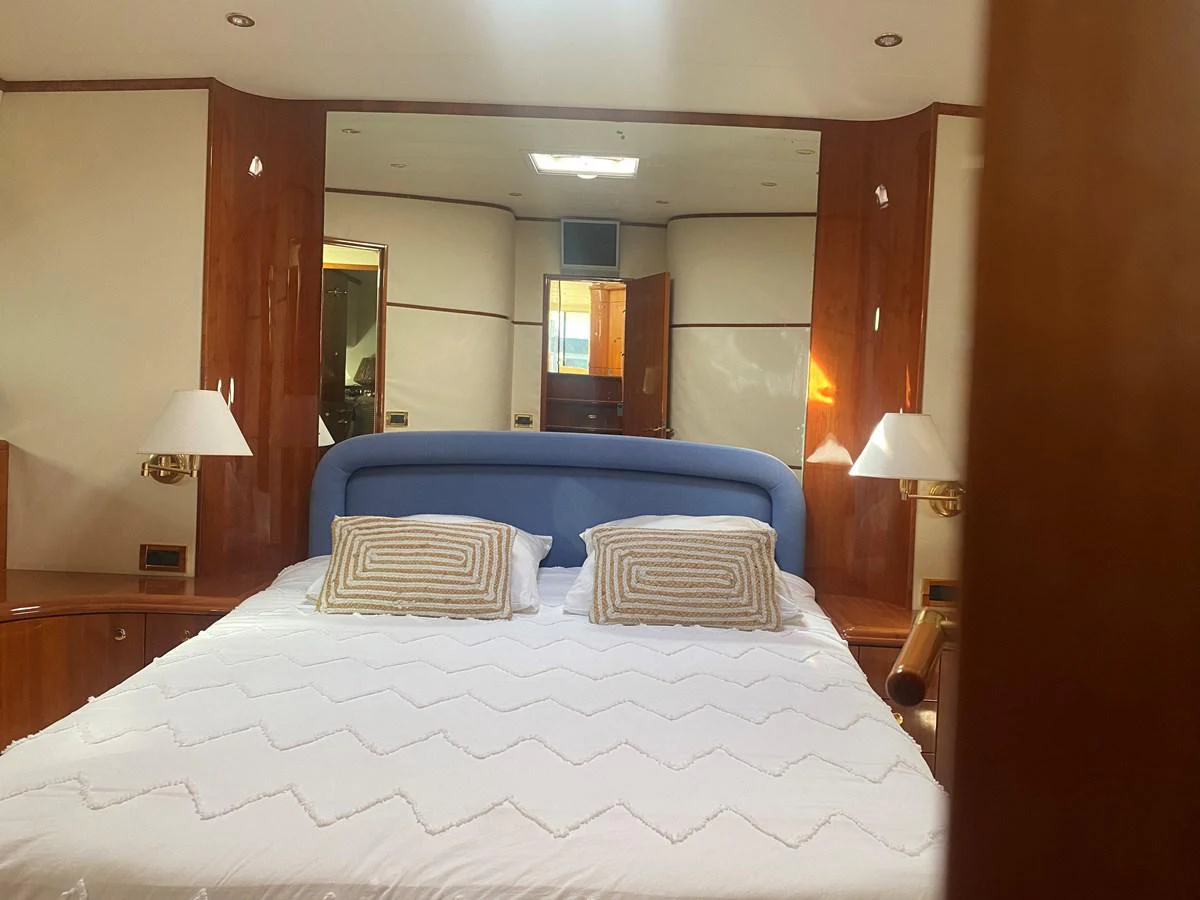 a bed with a white sheet aboard AMADEUS Yacht for Sale