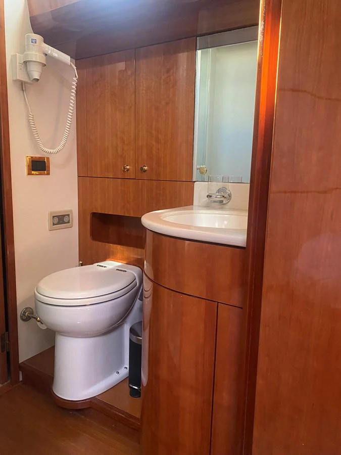 a bathroom with a toilet and sink aboard AMADEUS Yacht for Sale
