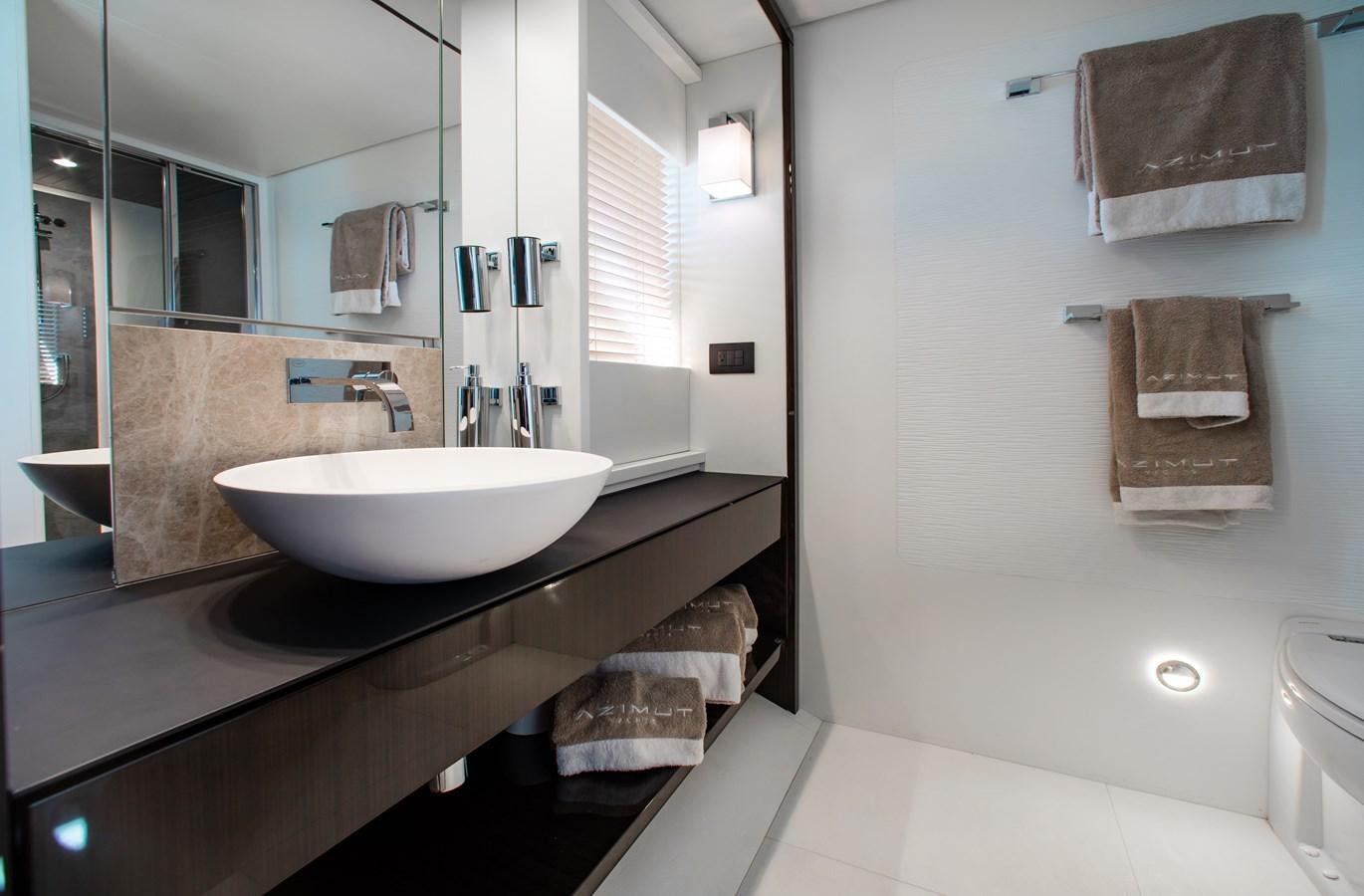 a bathroom with a sink and towels aboard ROLLING LOUD Yacht for Sale