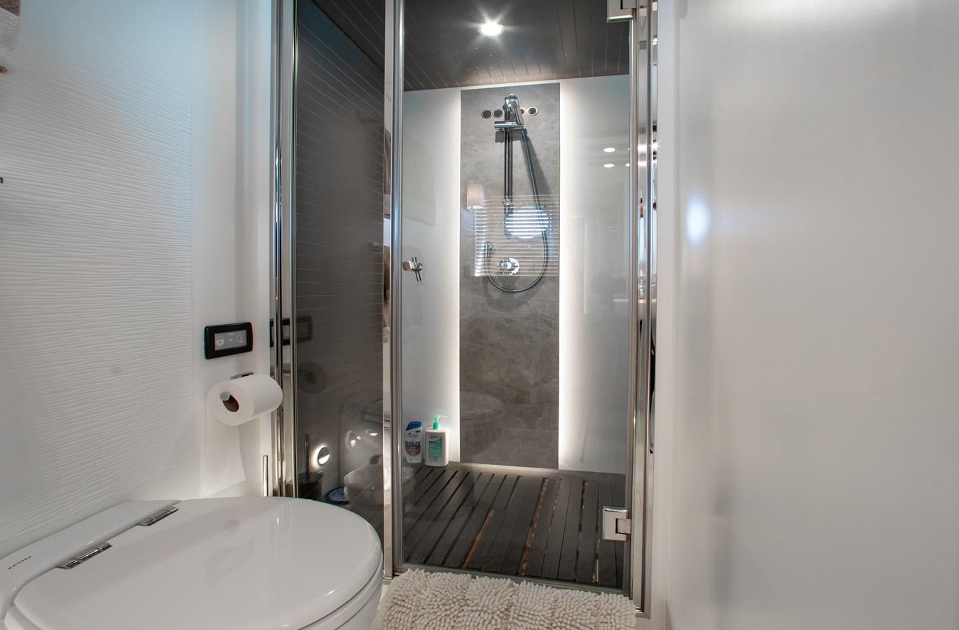 a bathroom with a glass shower aboard ROLLING LOUD Yacht for Sale
