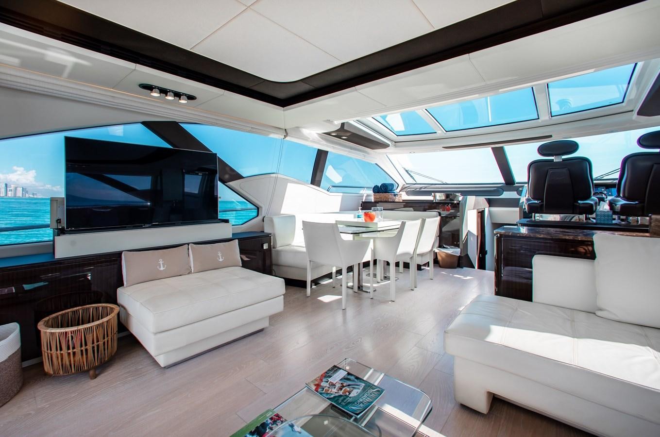 a living room with a large screen aboard ROLLING LOUD Yacht for Sale
