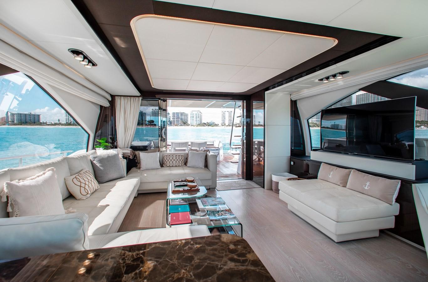 a living room with a large flat screen television and a large window aboard ROLLING LOUD Yacht for Sale