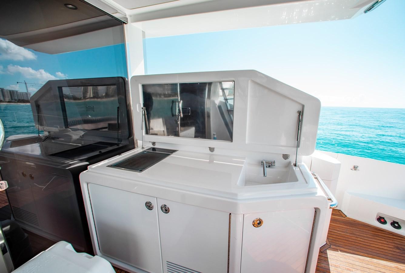 a white kitchen with a large window aboard ROLLING LOUD Yacht for Sale