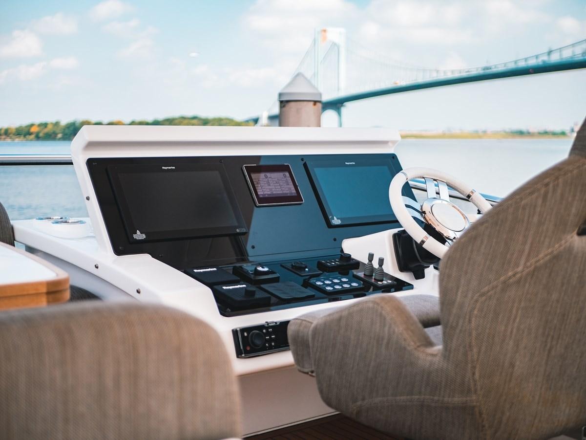 a person driving a boat aboard EVADO Yacht for Sale