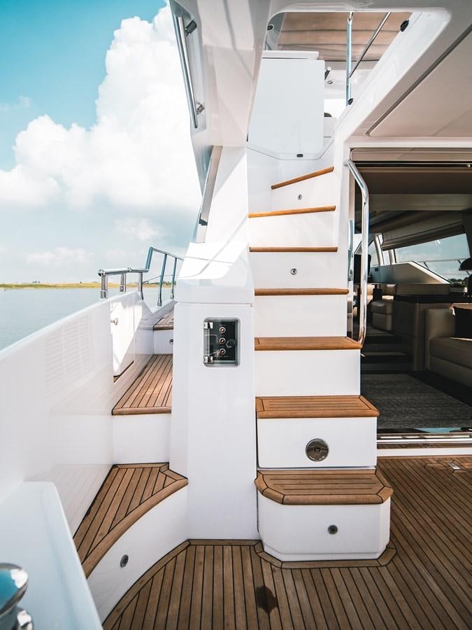 a white boat on a dock aboard EVADO Yacht for Sale