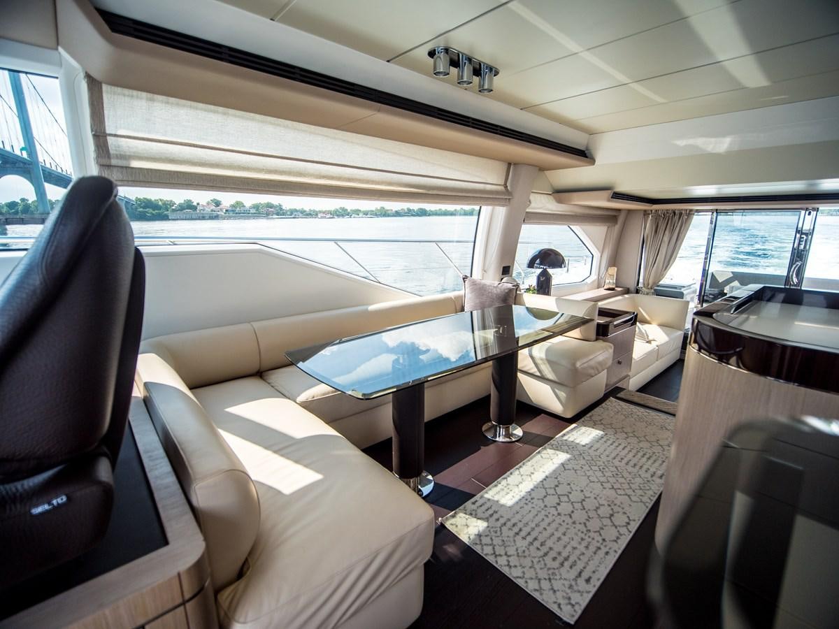 inside of a vehicle with a pool table and chairs aboard EVADO Yacht for Sale