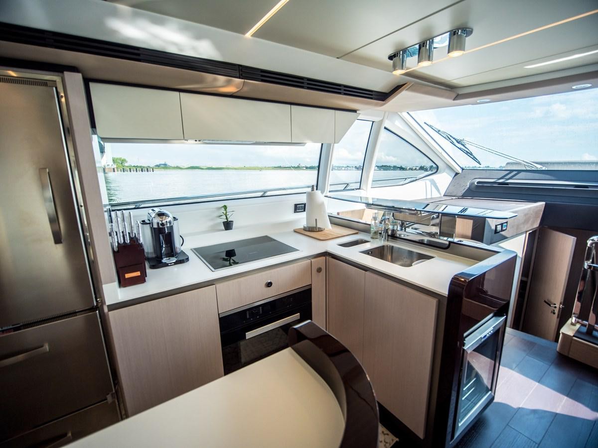 a kitchen with a large window aboard EVADO Yacht for Sale