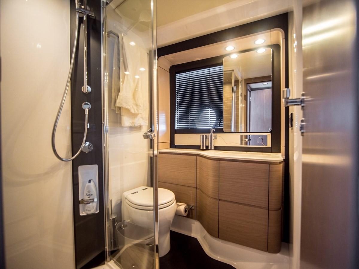 a bathroom with a toilet and a shower unit aboard EVADO Yacht for Sale