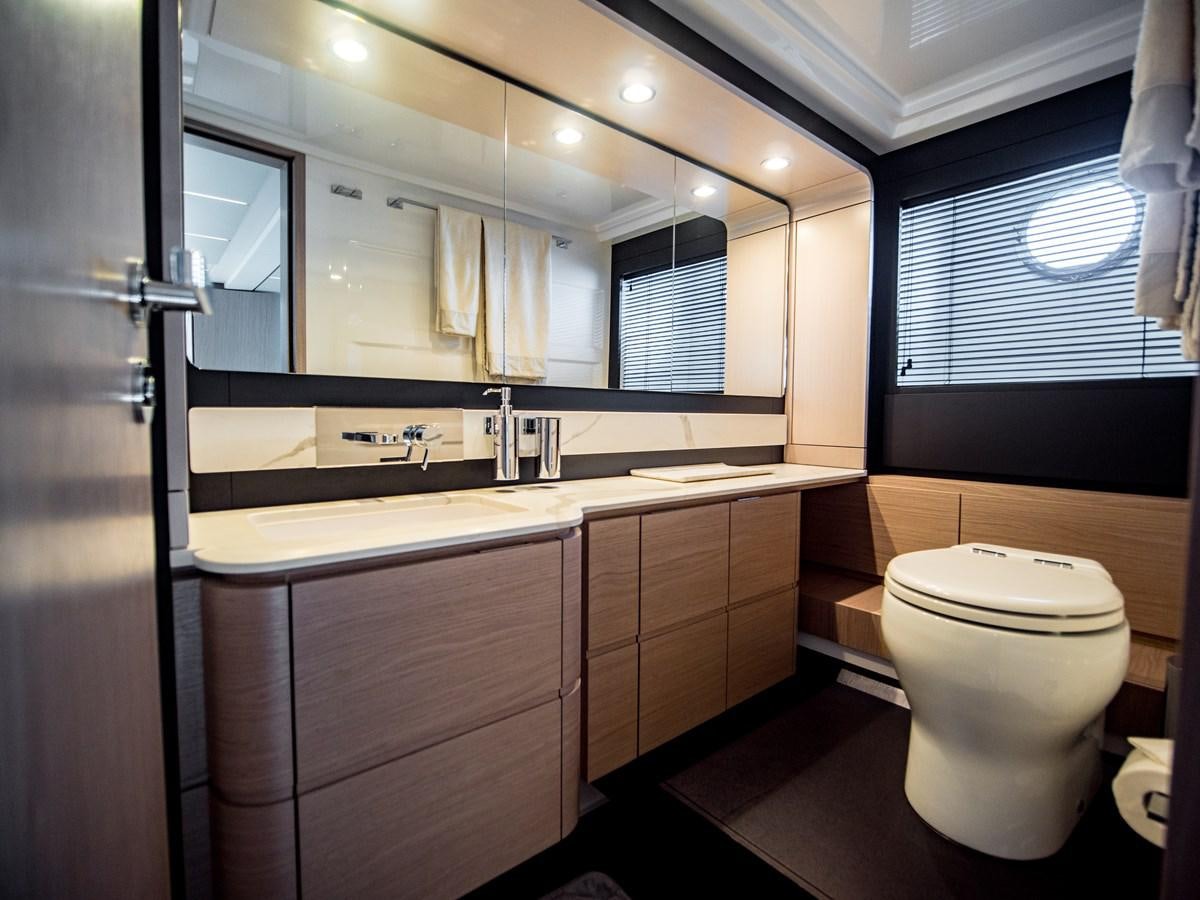 a bathroom with a large mirror aboard EVADO Yacht for Sale