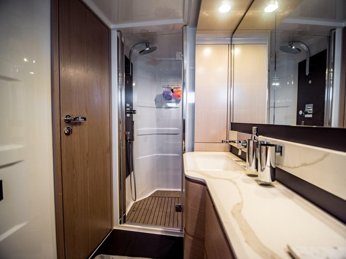 a bathroom with a large mirror aboard EVADO Yacht for Sale