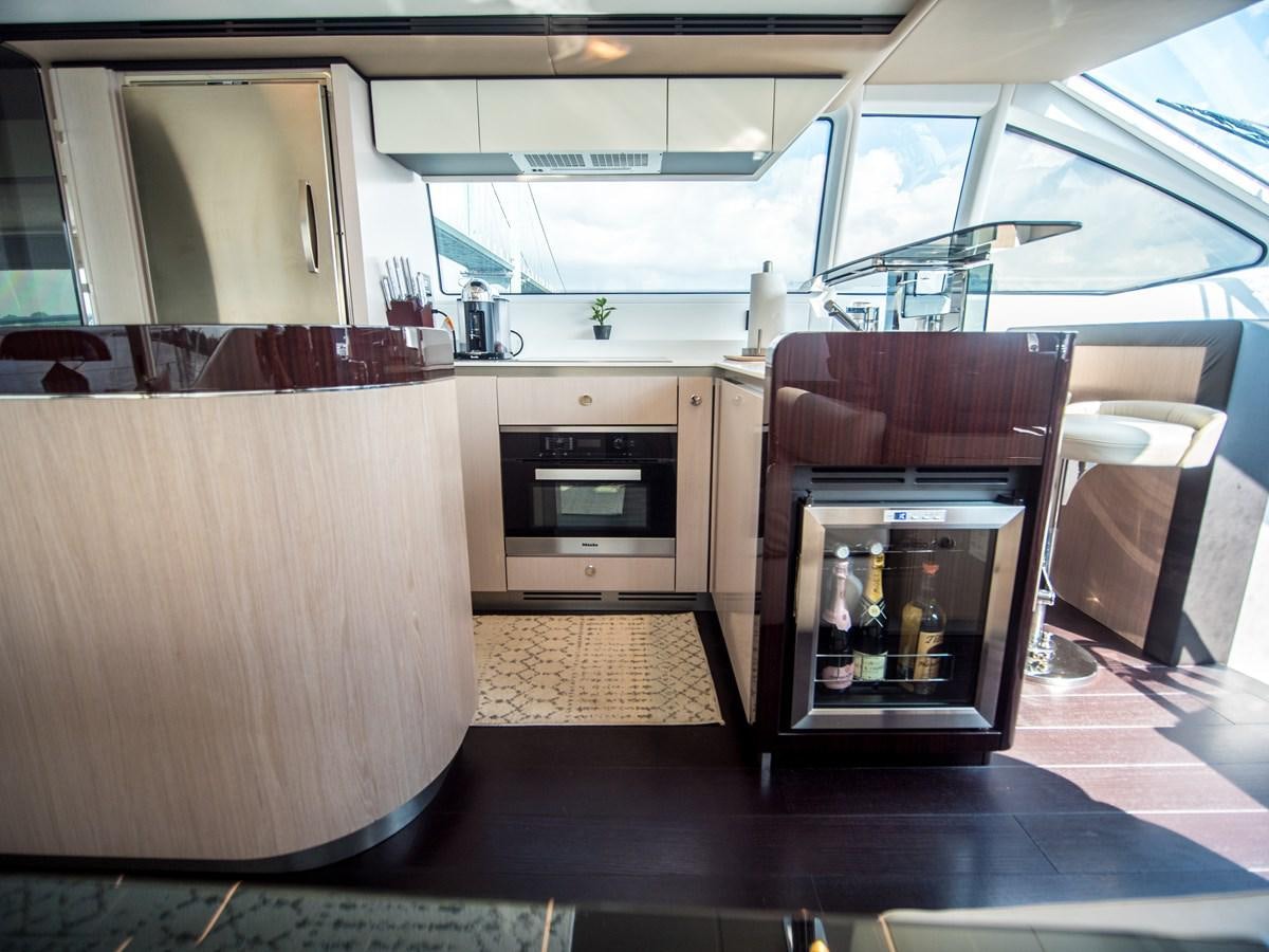 a kitchen with a glass door aboard EVADO Yacht for Sale