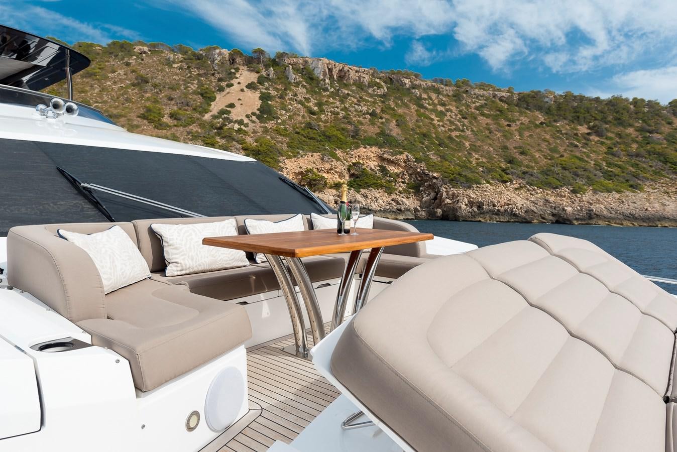 a lounge chair and a table on a boat on a body of water aboard AFTER 8 II Yacht for Sale