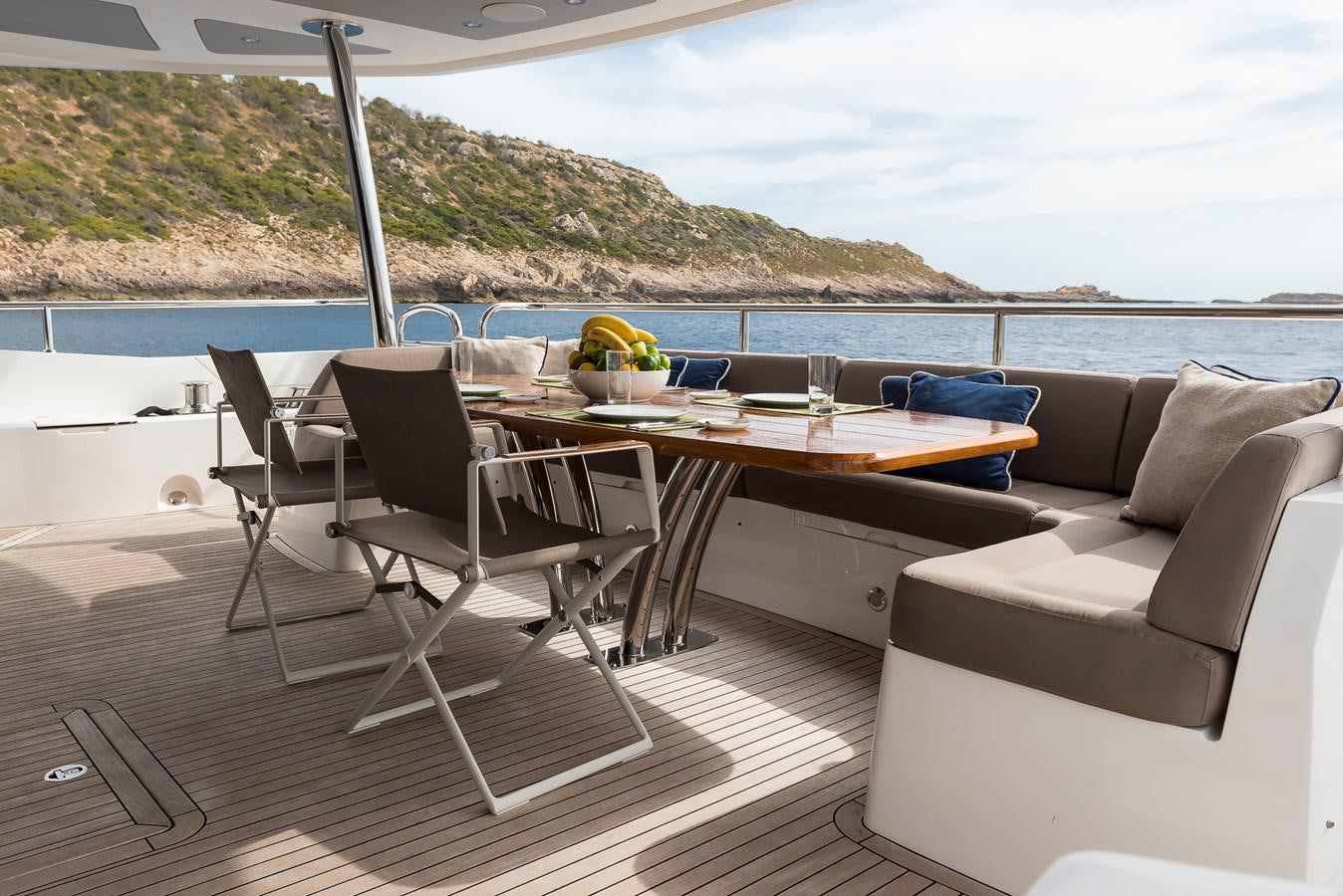 a table and chairs on a deck overlooking a body of water aboard AFTER 8 II Yacht for Sale