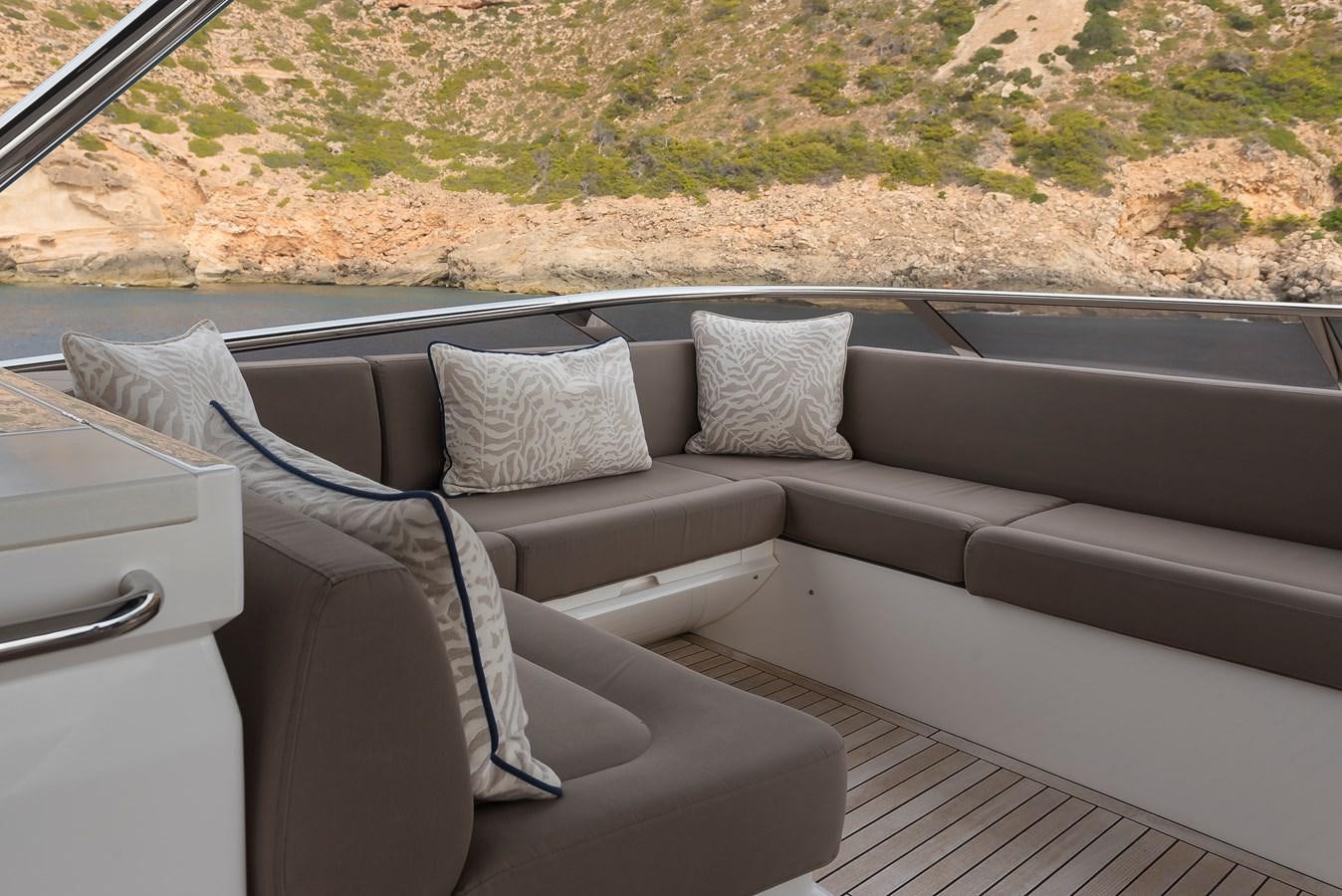 a couch with pillows on it aboard AFTER 8 II Yacht for Sale