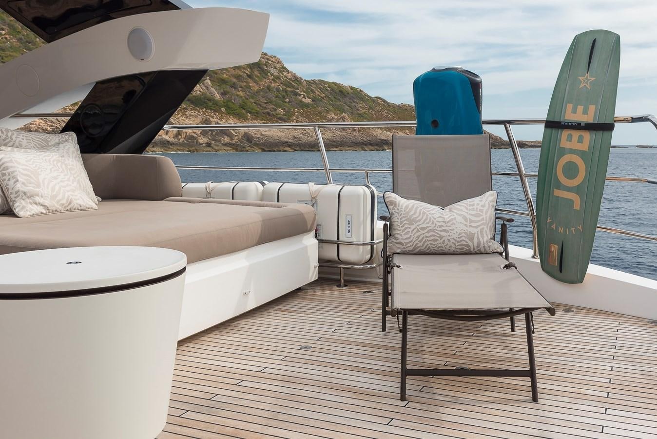a deck with chairs and a surfboard on it aboard AFTER 8 II Yacht for Sale