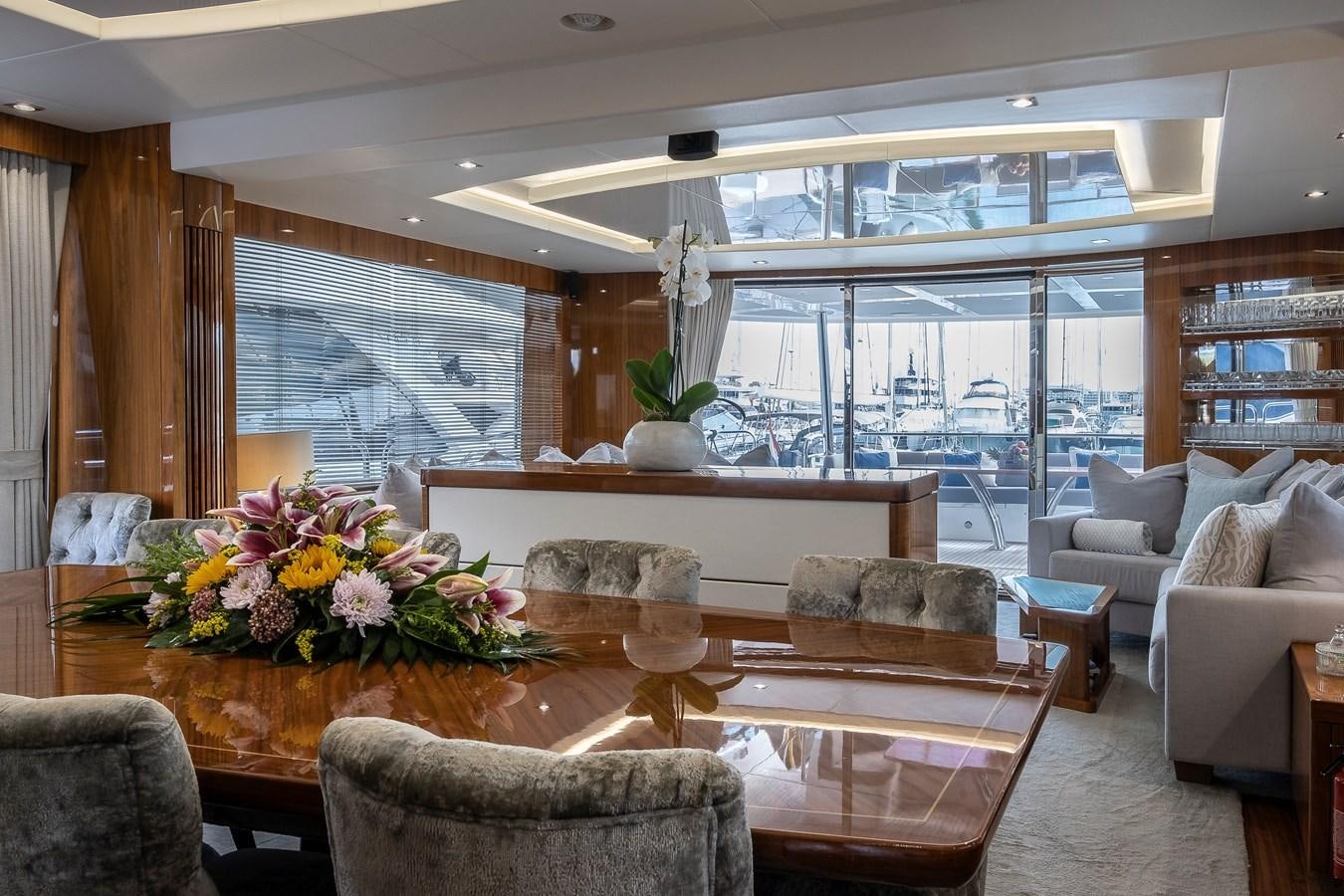 a living room with a large table and chairs aboard AFTER 8 II Yacht for Sale