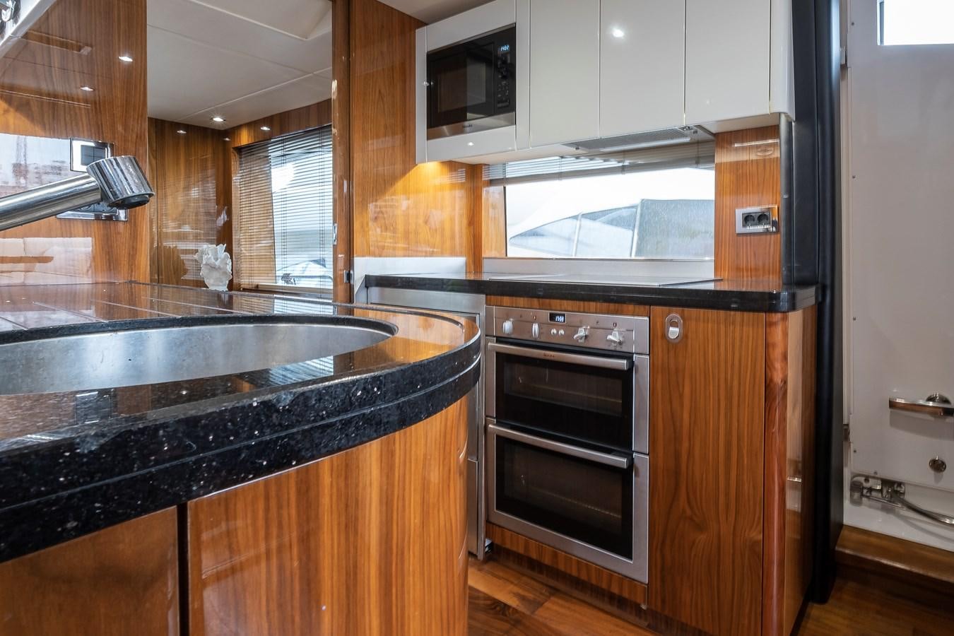 a kitchen with wooden cabinets aboard AFTER 8 II Yacht for Sale