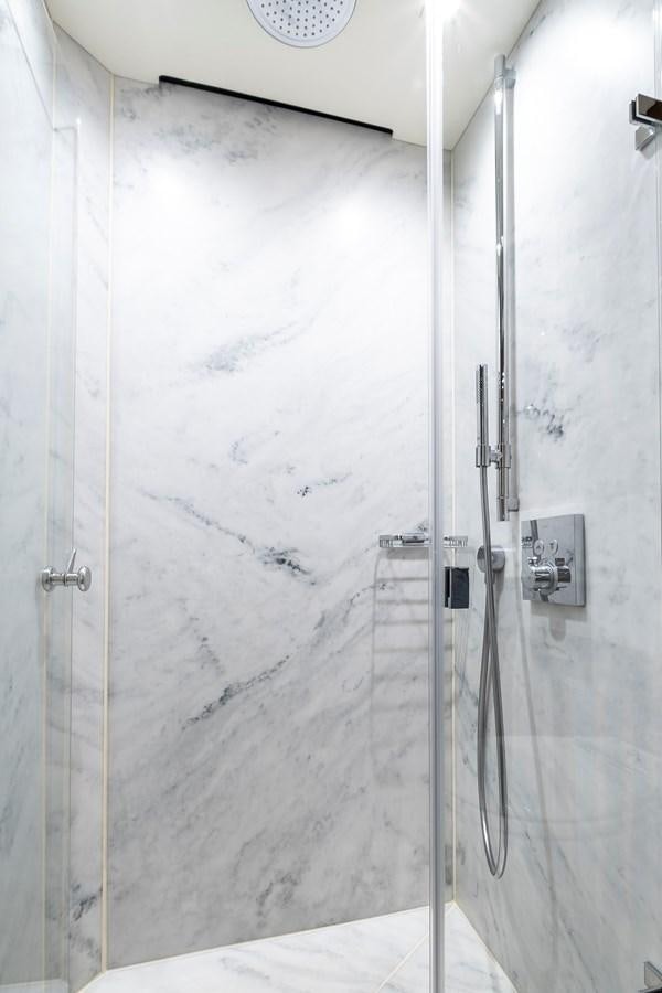 a shower with a white wall aboard AFTER 8 II Yacht for Sale