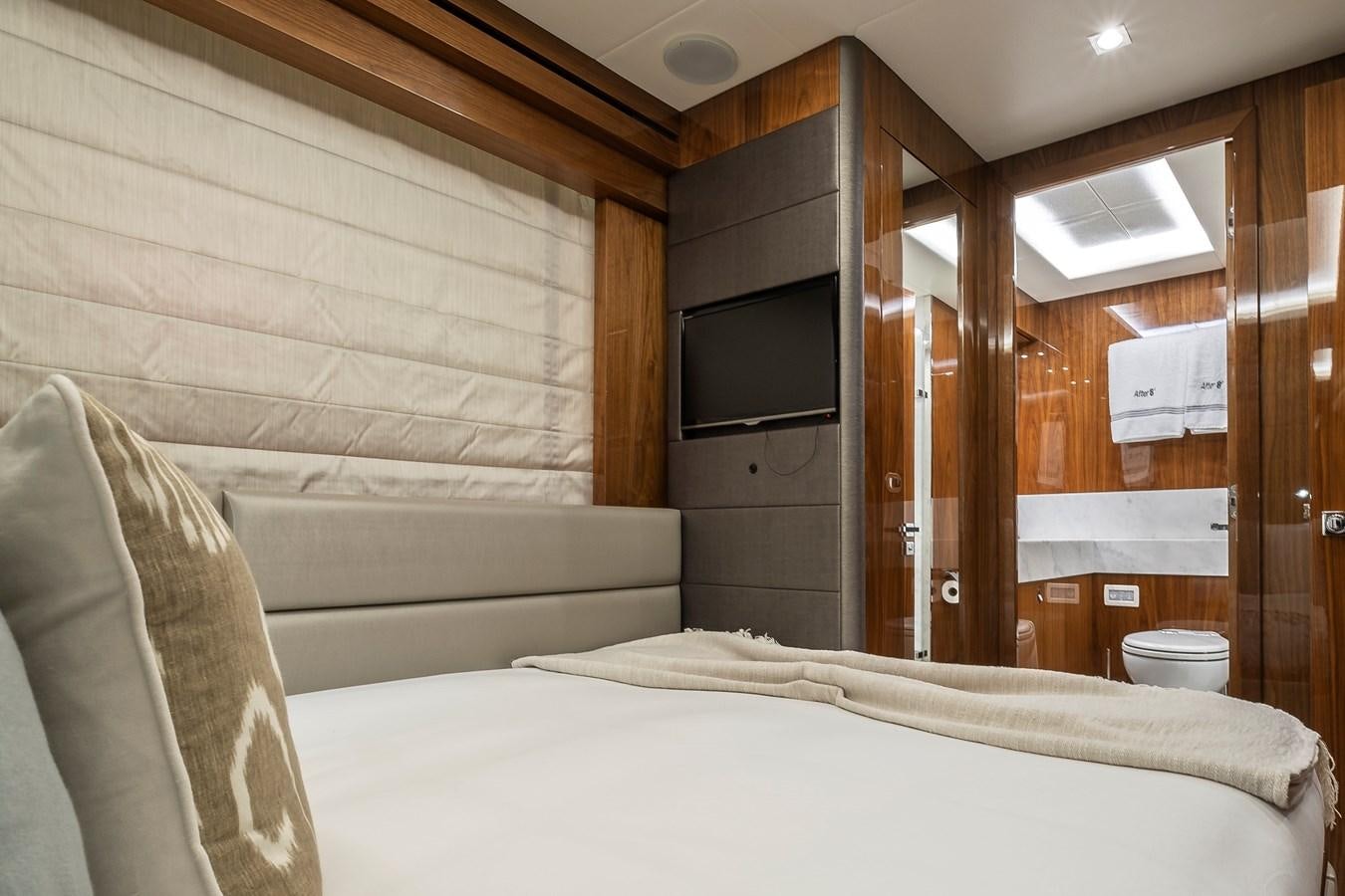 a room with a bed and a television aboard AFTER 8 II Yacht for Sale