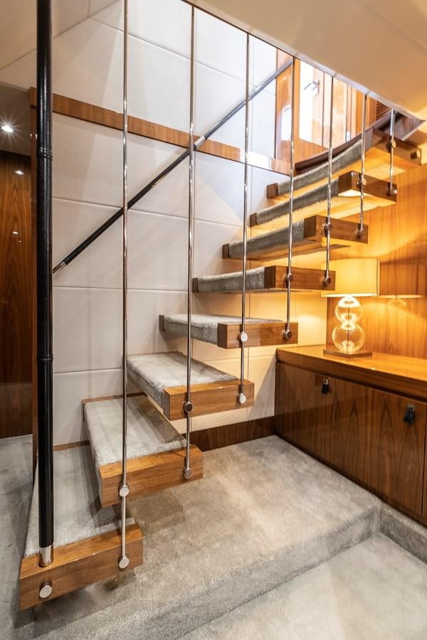 a room with a wood staircase aboard AFTER 8 II Yacht for Sale