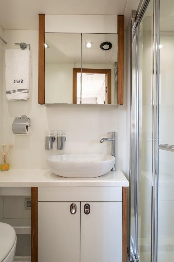 a bathroom with a sink and mirror aboard AFTER 8 II Yacht for Sale