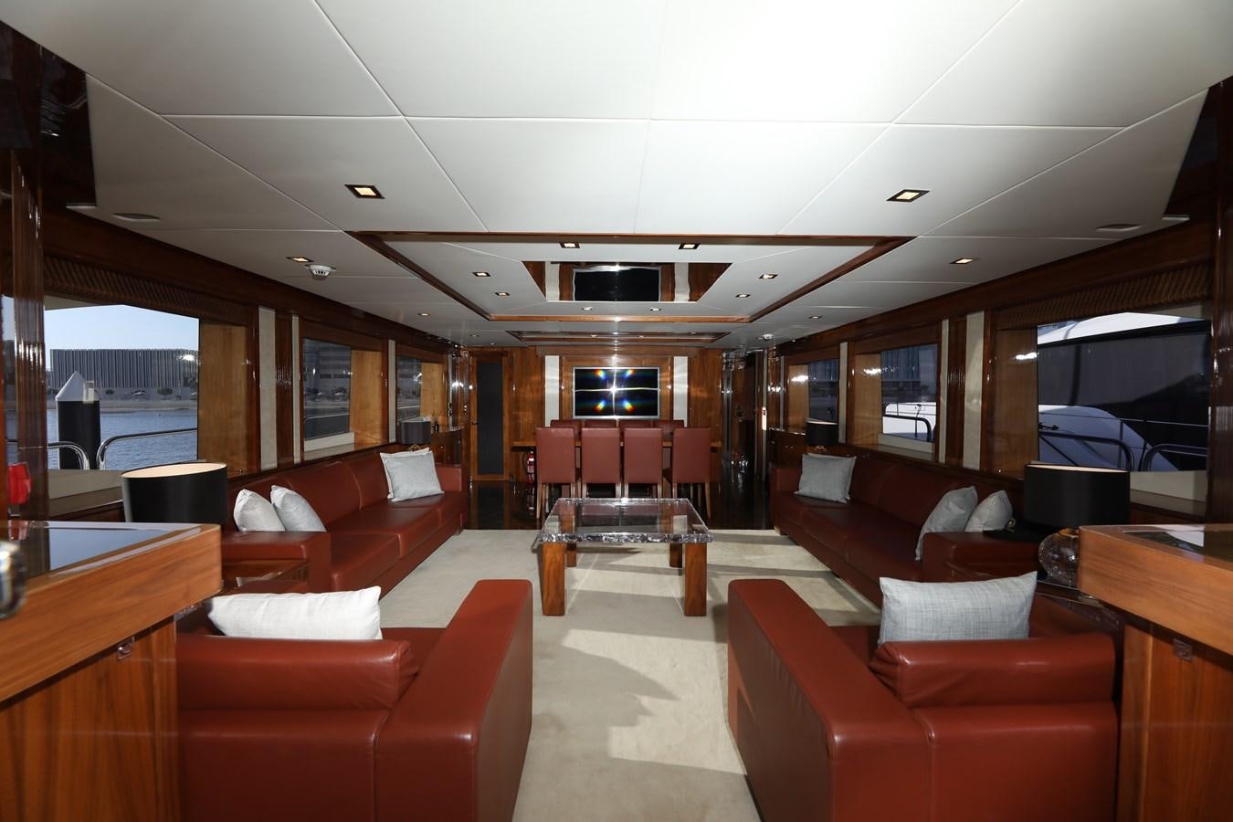 a room with red couches and a large window aboard SUNSEEKER 30M Yacht for Sale