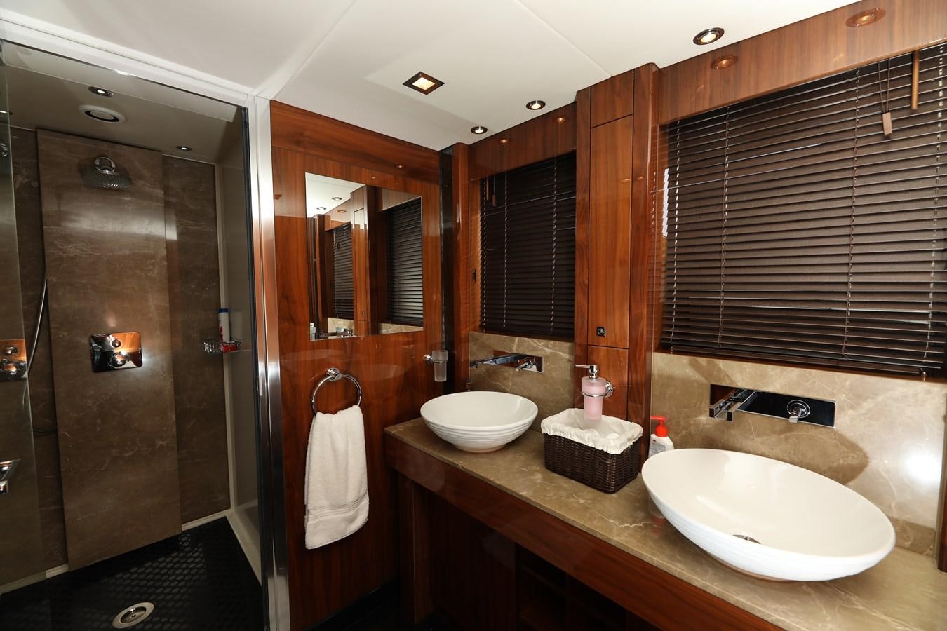 a bathroom with a sink and a shower unit aboard SUNSEEKER 30M Yacht for Sale