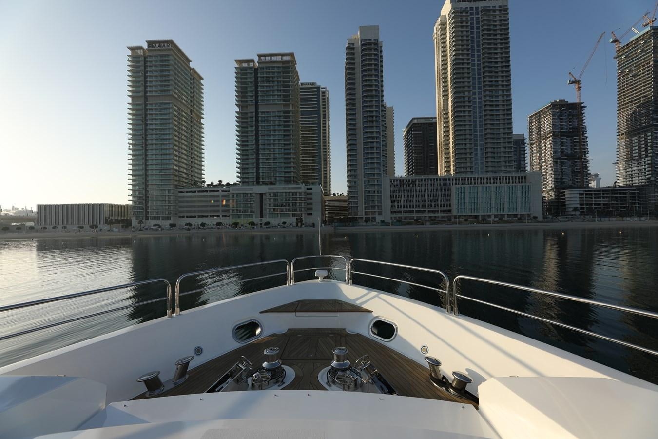 a city skyline with a large building aboard SUNSEEKER 30M Yacht for Sale