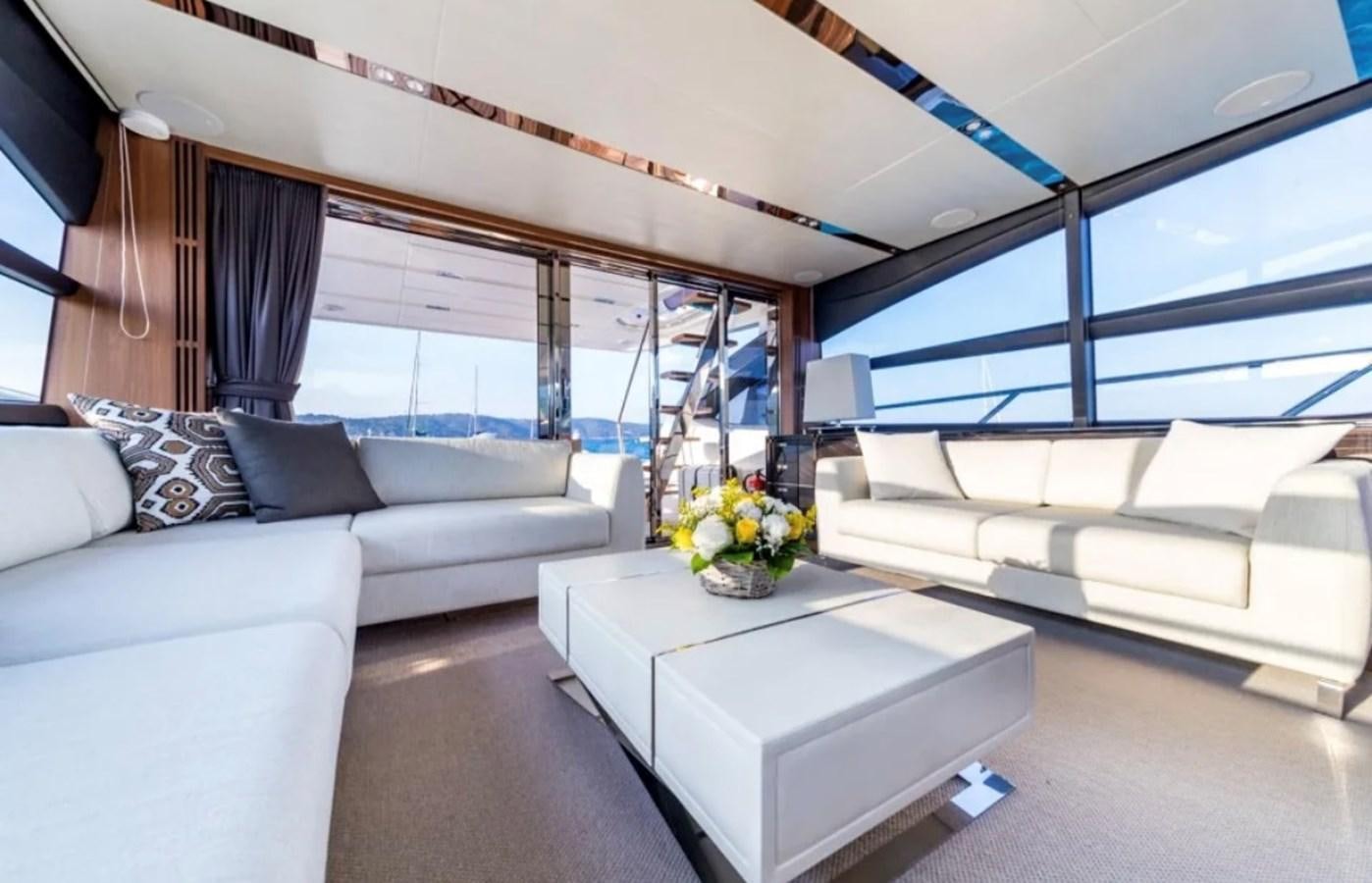 a room with a couch and a table aboard PRINCESS S72 Yacht for Sale