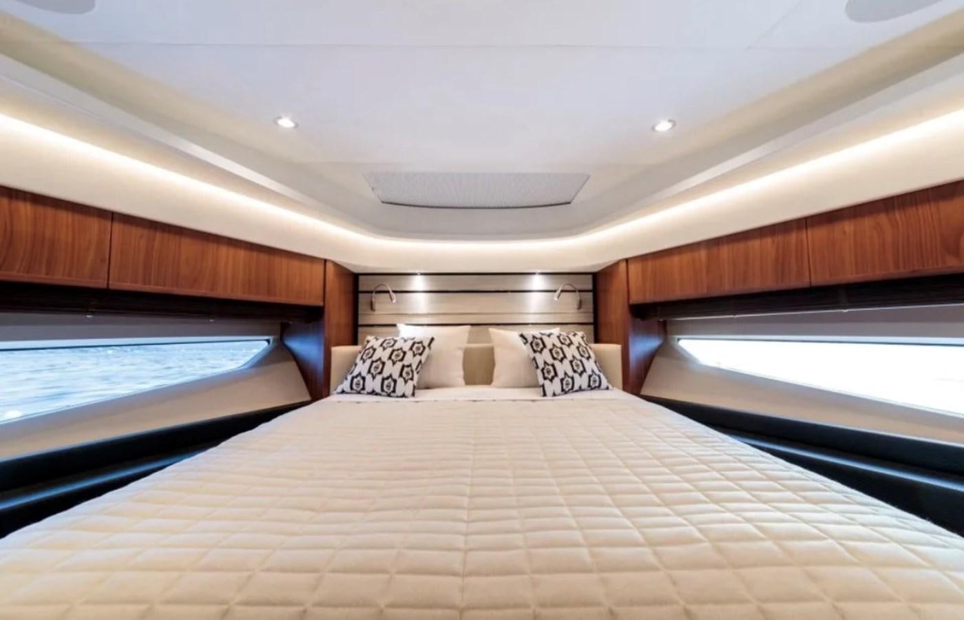 a bed with a white bed spread aboard PRINCESS S72 Yacht for Sale