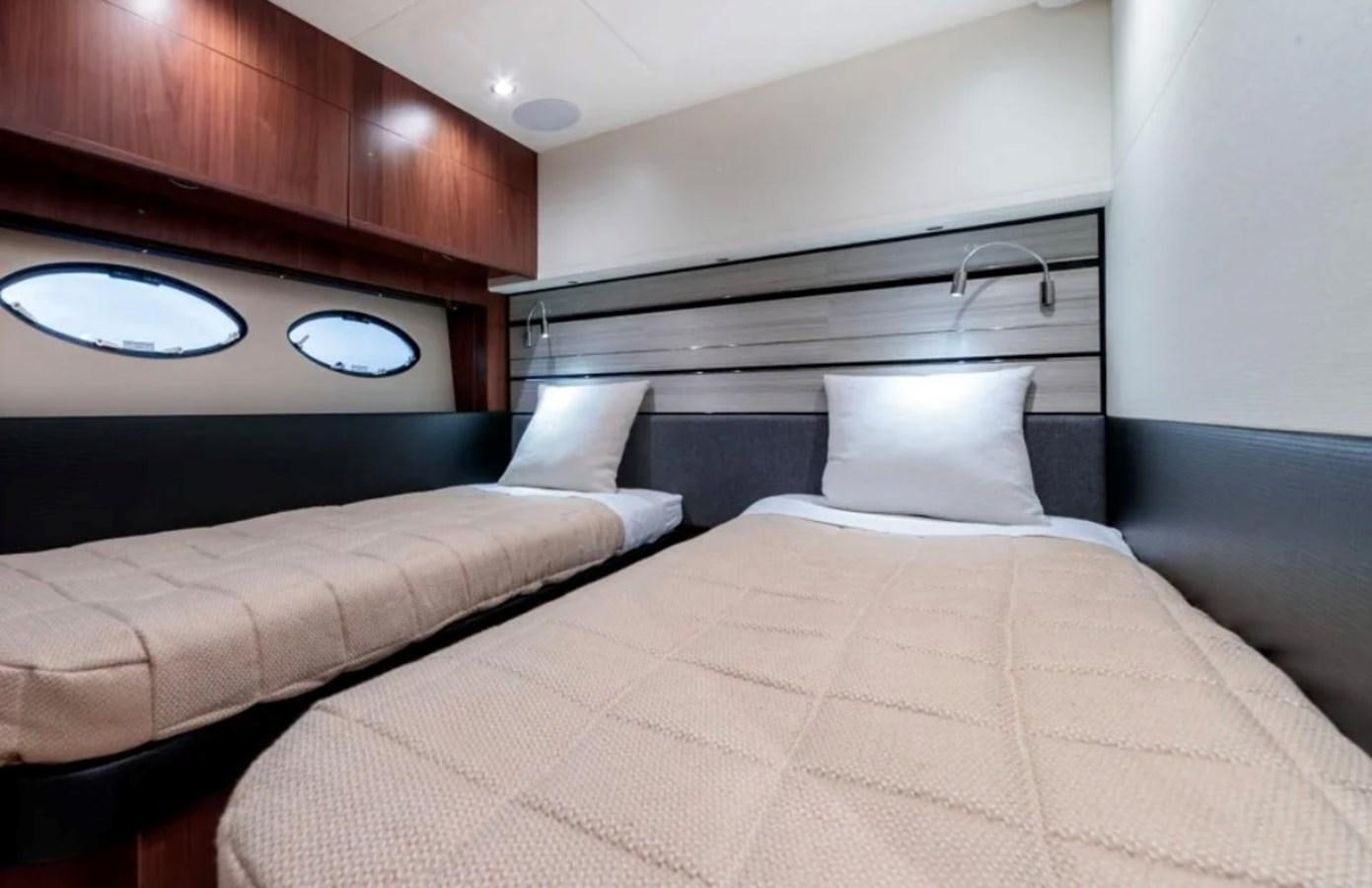 a bed with a white cover aboard PRINCESS S72 Yacht for Sale