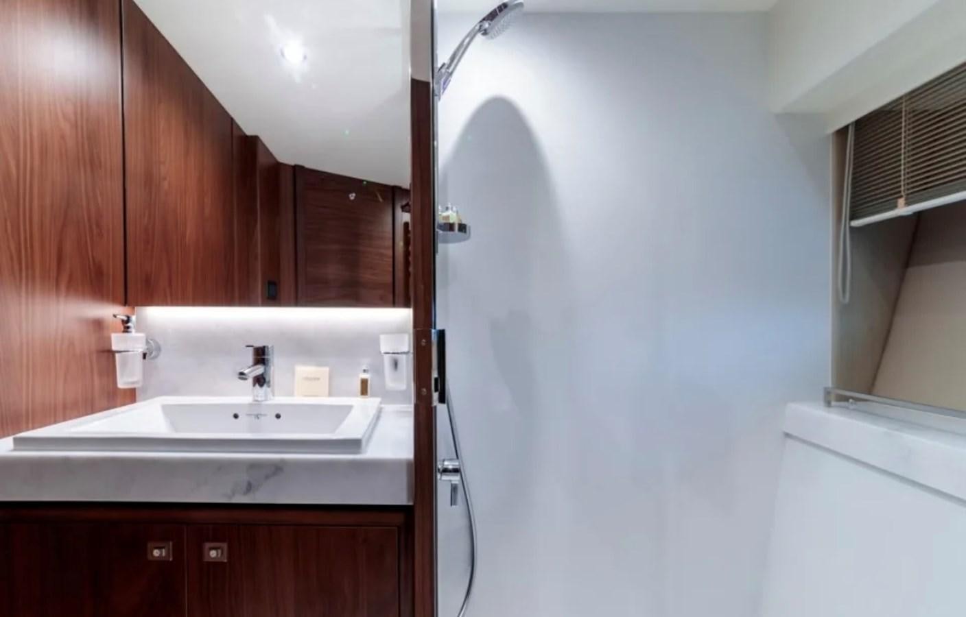 a bathroom with a sink and cabinets aboard PRINCESS S72 Yacht for Sale