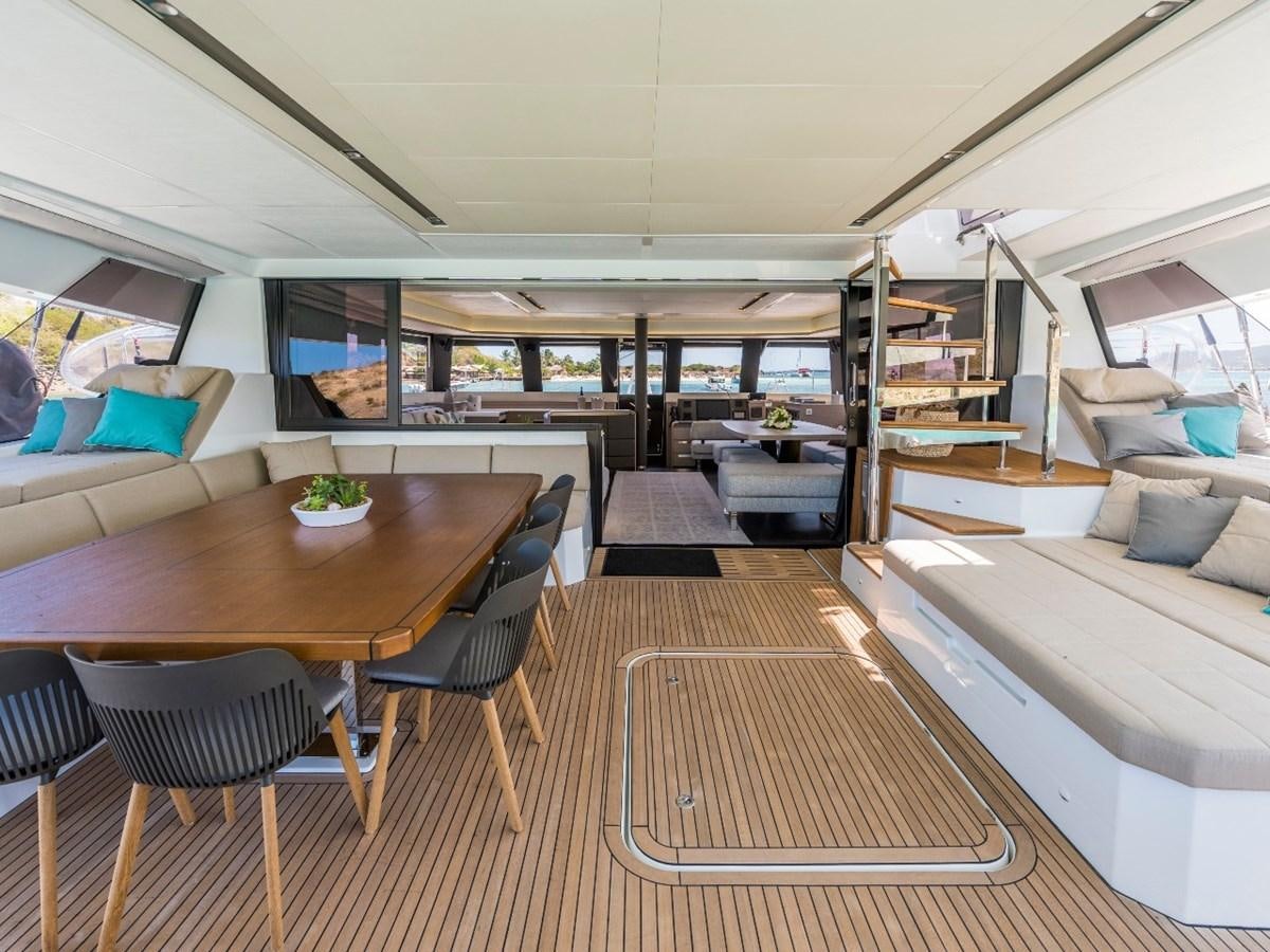 a room with a table and chairs aboard LISA OF THE SEAS Yacht for Sale