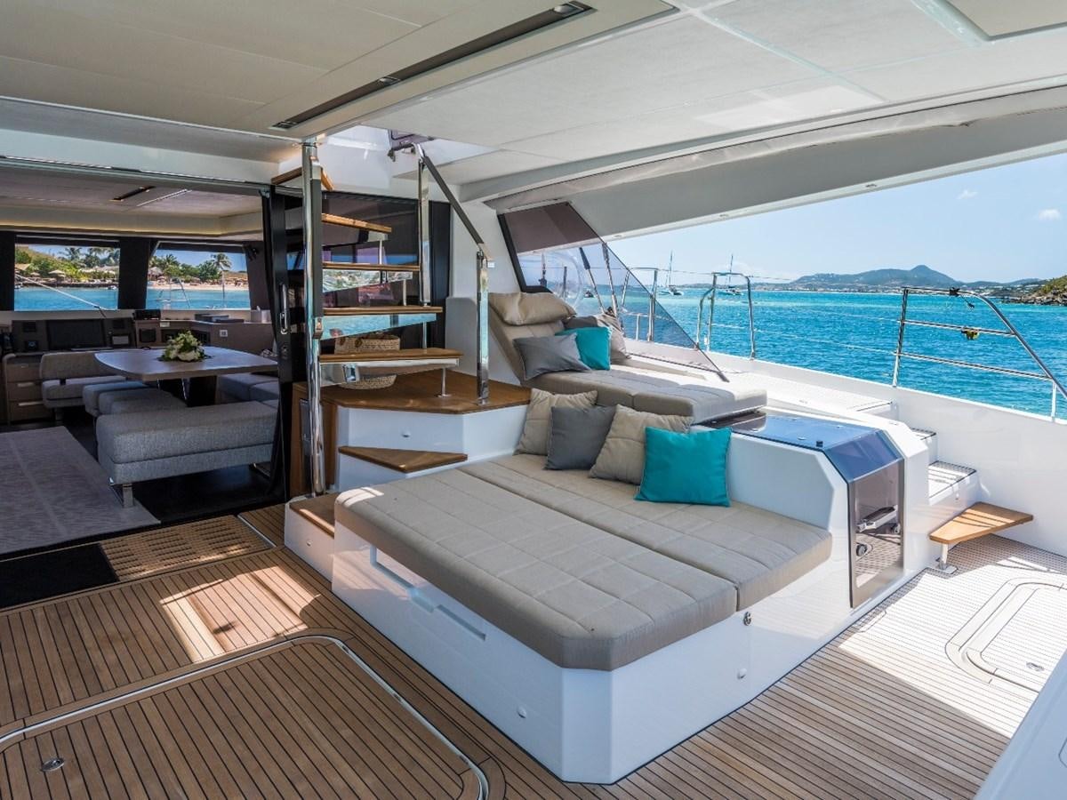 a living room with a large bed aboard LISA OF THE SEAS Yacht for Sale