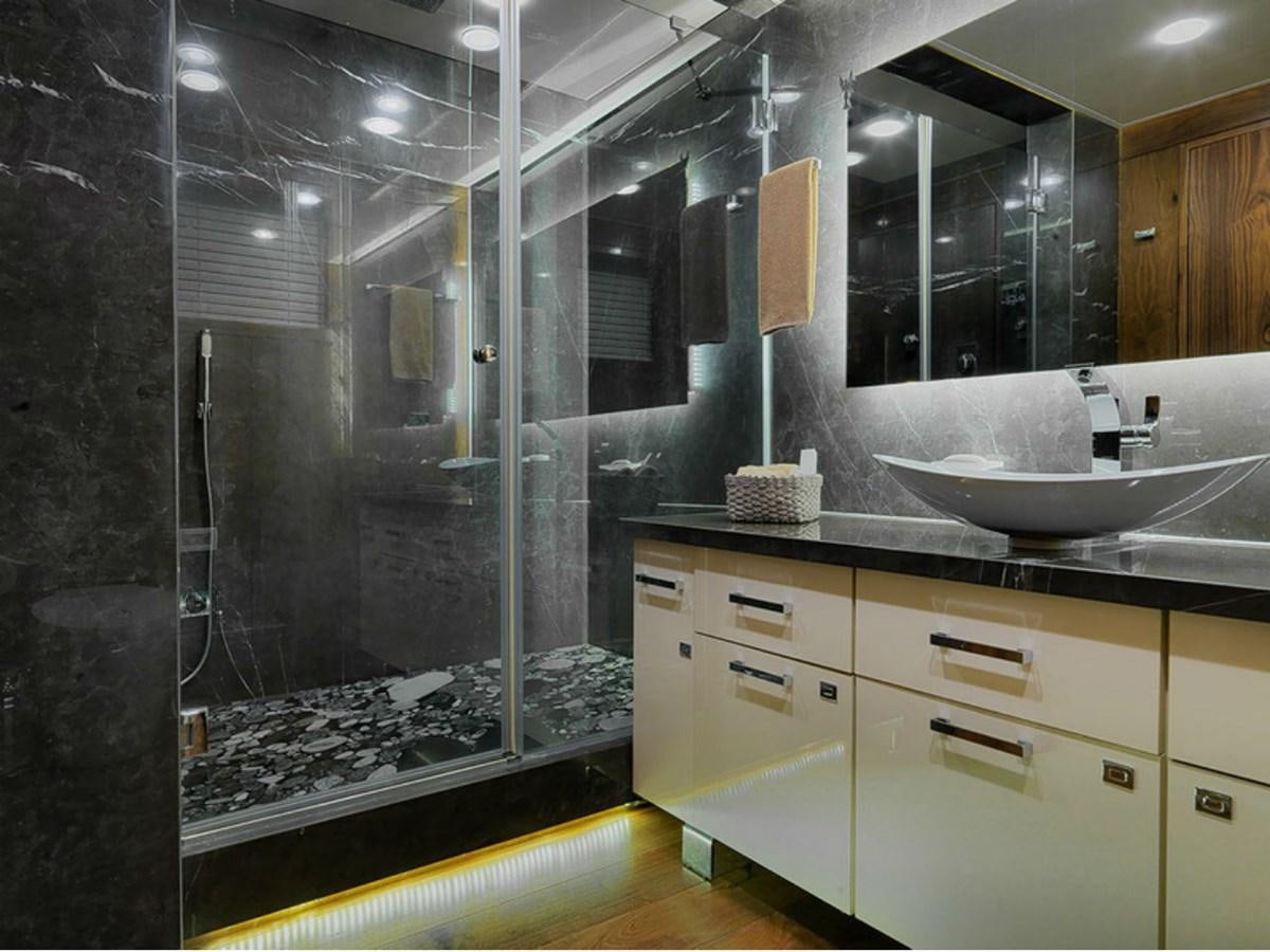 a bathroom with a large glass shower aboard LISA OF THE SEAS Yacht for Sale