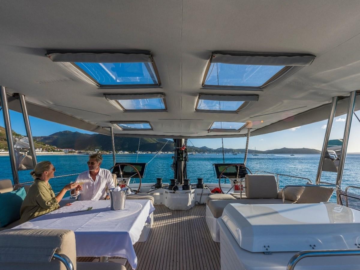 a couple of people sitting at a table on a boat aboard LISA OF THE SEAS Yacht for Sale