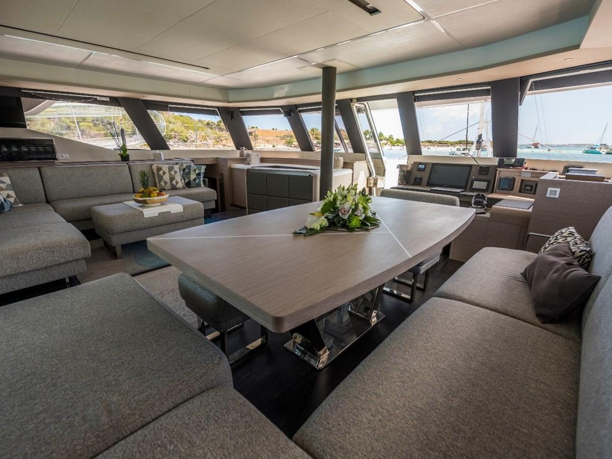 a room with a table and couches aboard LISA OF THE SEAS Yacht for Sale