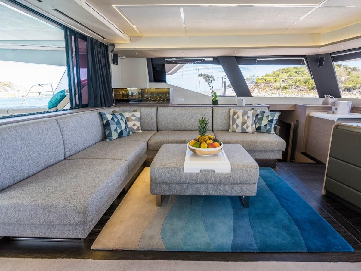 a living room with a couch and a coffee table aboard LISA OF THE SEAS Yacht for Sale