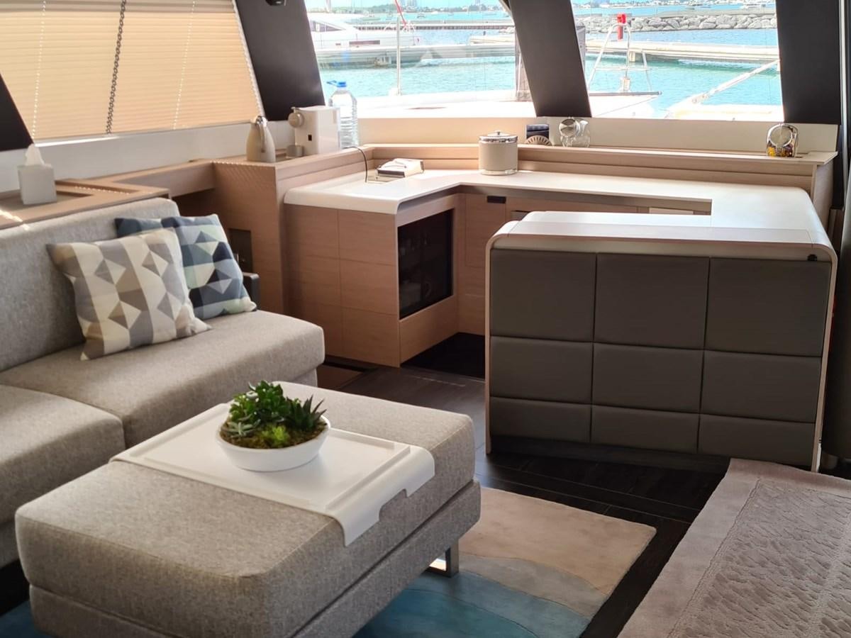a room with a couch and a plant on the table aboard LISA OF THE SEAS Yacht for Sale